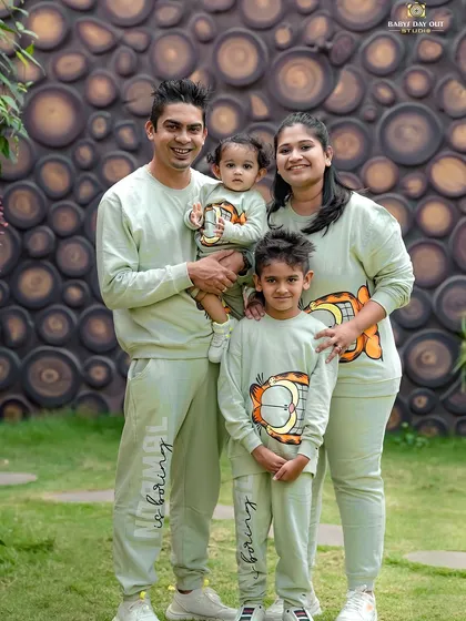 A perfect family day out. We love it when families coordinate their outfits, like these adorable matching sweatshirts. This outdoor portrait captures the happy, united spirit of this family of four.