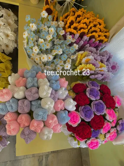 Buckets filled with pastel-colored tulips, forget-me-nots, and multi-colored rose bouquets.