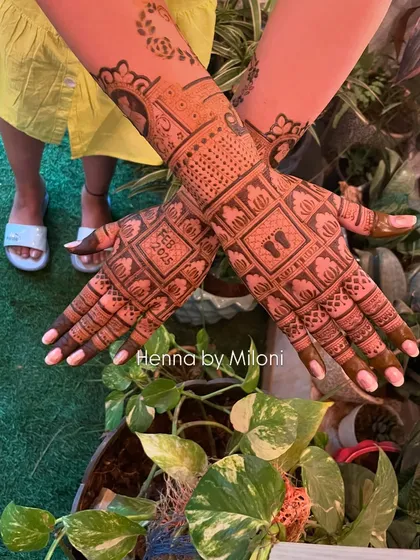 A beautiful baby shower mehendi with personalized details. The design includes baby footprints, the due date "FEB 2025," and other cute motifs.