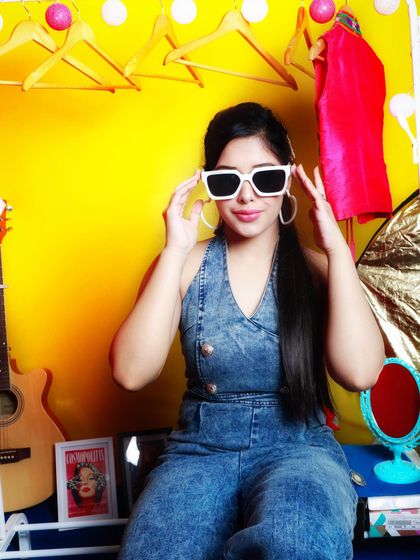 A denim jumpsuit is a stylish and comfortable one-piece outfit. I styled this one with bold white sunglasses for a retro-inspired, playful look.