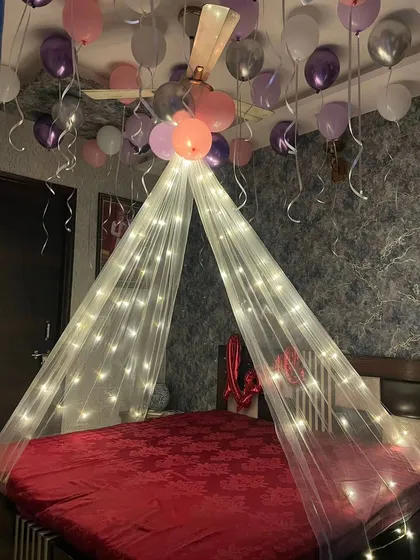 A simple and dreamy birthday bedroom decor. I used a fairy light canopy to create a focal point over the bed, with pink, purple, and silver balloons floating on the ceiling for a soft, celebratory feel.