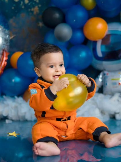 A happy little astronaut playing with a balloon planet. This creative and colorful space-themed setup is perfect for a child's imagination.