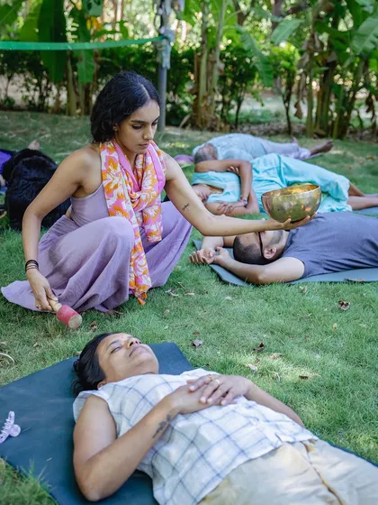 I offer a moment of deep relaxation with a singing bowl during an outdoor sound healing session. This personal, focused attention is a key part of the experience, allowing each individual to receive the healing vibrations of sound in a serene, natural setting.