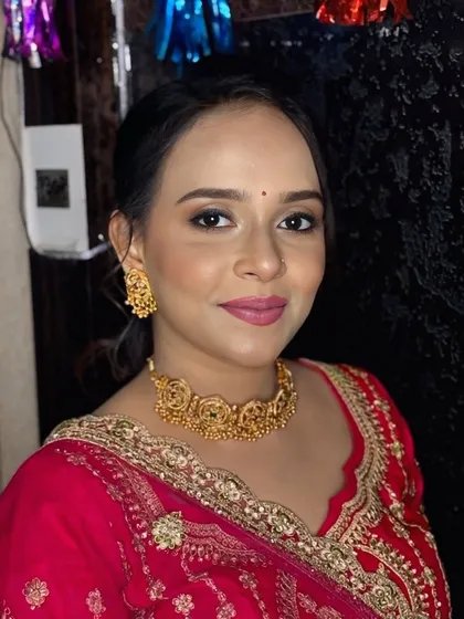 A front-facing portrait of the bride's sister. The makeup is perfectly balanced, with a soft pink lip and defined eyes.