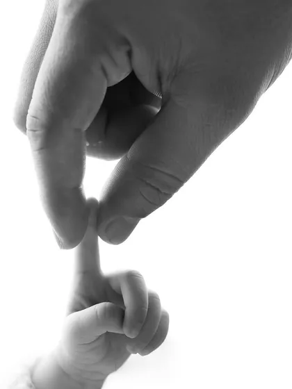 The tiniest details tell the biggest stories. This simple, powerful image of a baby's hand holding a parent's finger is a beautiful symbol of the forever bond you share.