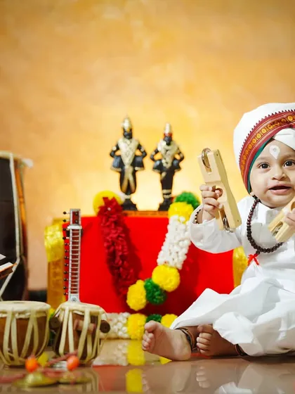 With a big smile and cymbals in hand, this little boy is the picture of joy and devotion.