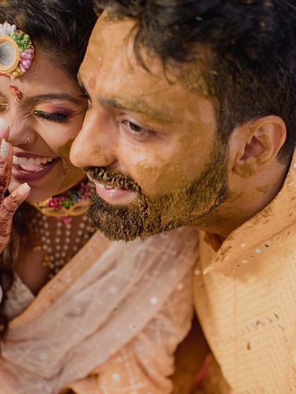A candid and happy moment between the couple. The bride's makeup remains flawless, capturing her beautiful smile and laughter.