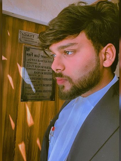 A candid moment of thought next to my firm's nameplate. Every case requires deep thought and strategic planning before any action is taken.