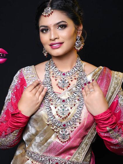 A full shot of the beautiful work done by my student. The silver-toned jewellery paired with the pink and gold saree is a beautiful combination.