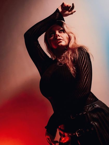 A creative portrait using colored lighting. This image was part of a personal post about mental health, using the contrasting colors to represent the struggle and the hope.