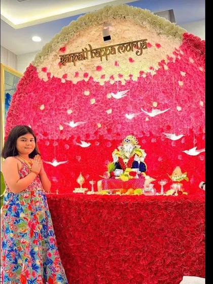For festivals, I create spectacular decor that honors tradition. This grand Ganpati backdrop is made entirely of pink and white flowers, forming an impressive arch over the idol, making it a beautiful centerpiece for home or society celebrations.