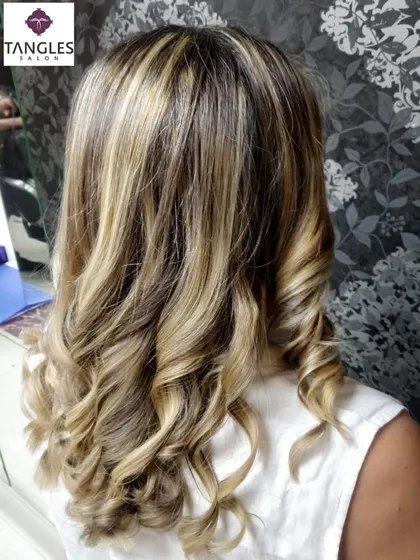 A classic for a reason. These golden blonde highlights add warmth and brightness, giving the hair a healthy, radiant shine. I focus on placing the highlights strategically to frame the face and create a natural, multi-tonal effect.