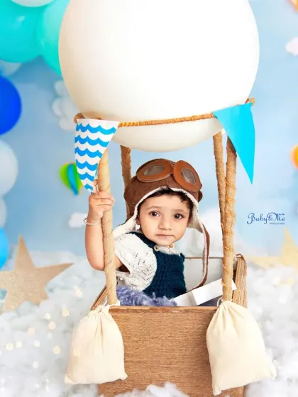 Holding on tight for his hot air balloon ride! This little aviator looks so handsome in his classic outfit and goggles.