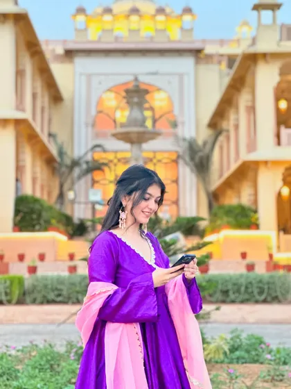 Checking my phone, but making it fashion. The details on this anarkali, from the fit to the color, were all carefully planned to create a standout look.