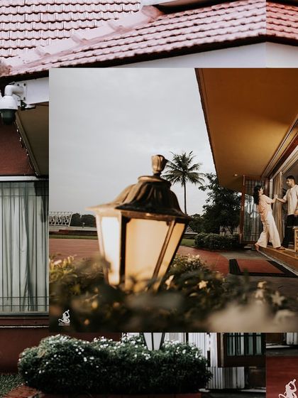 An artistic shot using a lantern in the foreground to frame a couple sharing a moment on their porch.