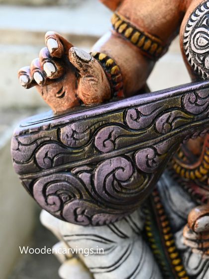 A detailed shot of the veena from the sold 36-inch Saraswathi statue, showing the intricate patterns carved into the instrument.