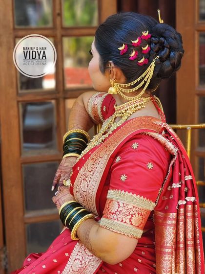 A view of the intricate braided bun created by my artist Vidya for Priya's wedding. The hairstyle is adorned with beautiful, traditional accessories.