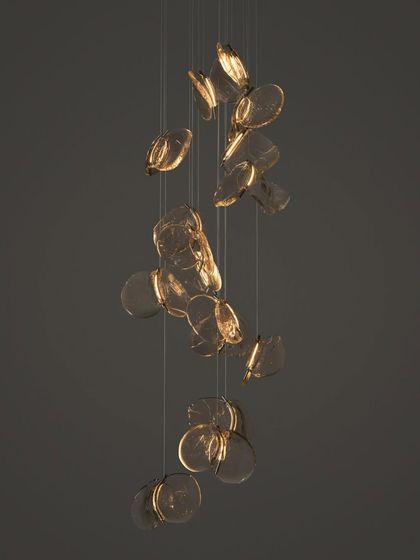 A cascading installation of the Bocci 141 series, with the pendants appearing to float downwards like falling leaves.