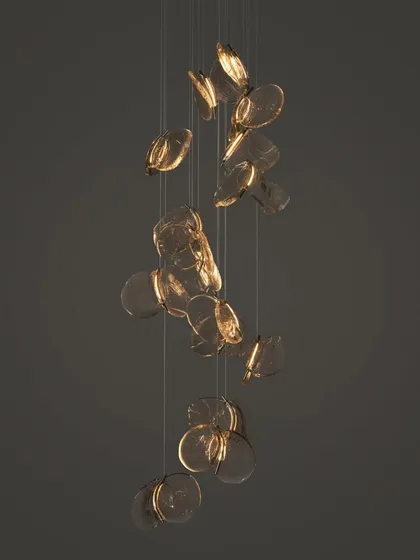 A cascading installation of the Bocci 141 series, with the pendants appearing to float downwards like falling leaves.