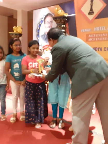Shivani receiving her third-place prize in the Under-8 category at a Blitz Rated Chess Tournament in Mandya. We train students for various formats of chess, including rapid and blitz.