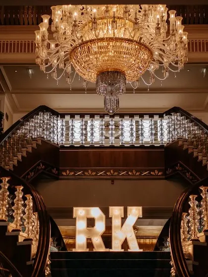 The grand entrance to a wedding celebration in Turkey, marked by the couple's initials, 'RK'. We work with planners to ensure every element of the event, from decor to dining, is cohesive and spectacular.