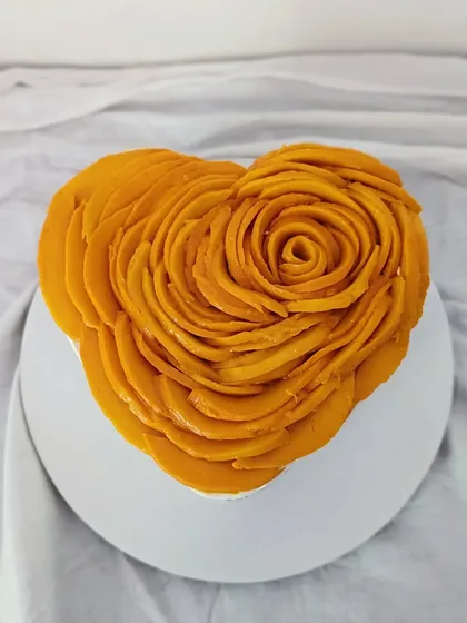 This heart-shaped mango cheesecake shows my love for beautiful presentation. Each slice of sweet Alphonso mango is carefully layered to form an edible rose, making it a stunning centerpiece for any special occasion.
