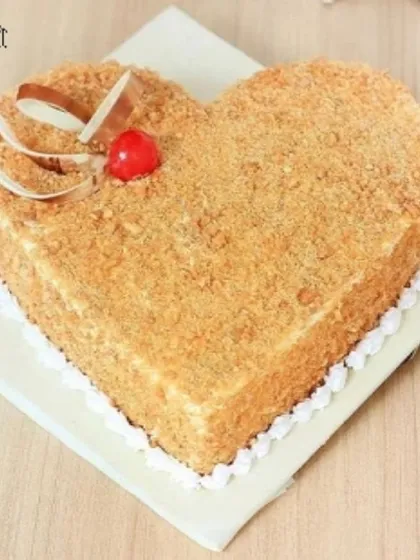 For a crunchy and sweet romantic treat, our heart-shaped butterscotch cake is an excellent choice. It's covered in delicious butterscotch crunch and topped with a cherry and chocolate garnish.