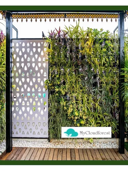 Modern design meets natural beauty in this entryway. I created a dense vertical garden that acts as a living wall, providing privacy and a burst of greenery. It is perfectly complemented by a sleek wooden deck and a custom-patterned metal screen, showcasing a blend of textures and materials.