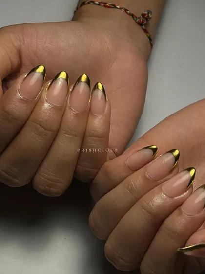 Chrome tips are always a win. This is a modern and chic take on the classic French manicure, using a solid gold chrome for the tips on long, almond-shaped nails.