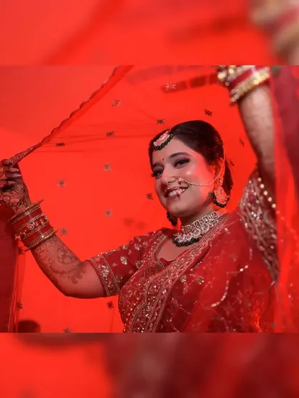 This artistic bridal portrait uses dramatic red lighting to create a striking and memorable image. I focus on capturing the bride's personality, here using the veil to frame her happy expression on her wedding day.