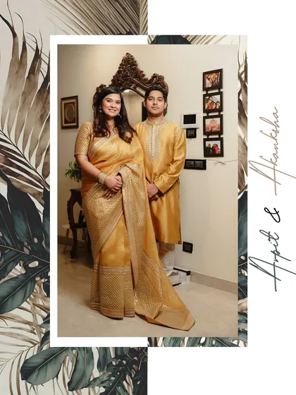 A full-length portrait of the couple from their Roka ceremony. This shot showcases their coordinated traditional outfits and the elegant home decor, providing a complete picture of their special day.