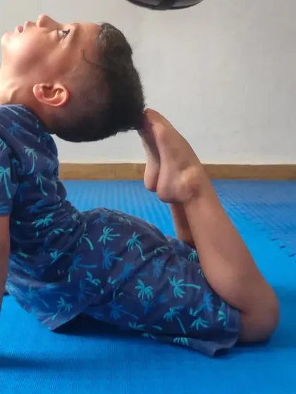 Another young martial artist working on his flexibility. We incorporate yoga and stretching into our classes to improve overall physical ability.