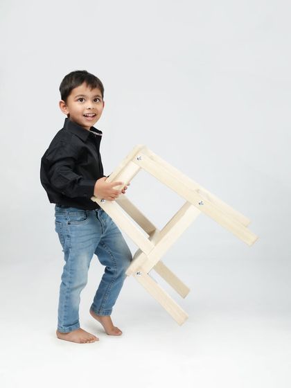 The playful energy of a toddler is just the best. This candid shot captures his happy expression and movement, creating a memory full of life.