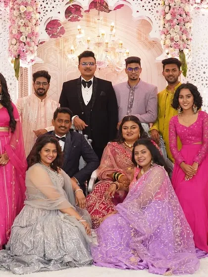 A formal group portrait of the couple with their friends and family, a beautiful memory of everyone who came to celebrate their union.
