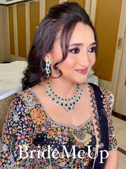 A side profile of Amita's reception look, showing off her glowing skin and the beautiful details of her jewellery.