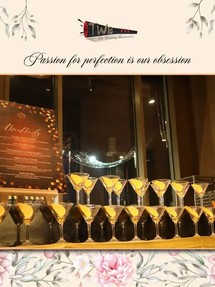 A display of pre-garnished martini glasses, ready for our signature Orange Thyme Martini mocktails at a grand reception.