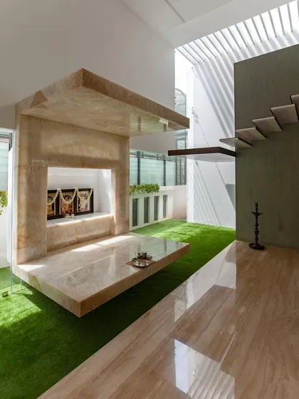 detail of a floating puja unit, constructed from backlit onyx to create a hovering, sacred space… the design integrates light and stone, appearing weightless against the indoor green court.