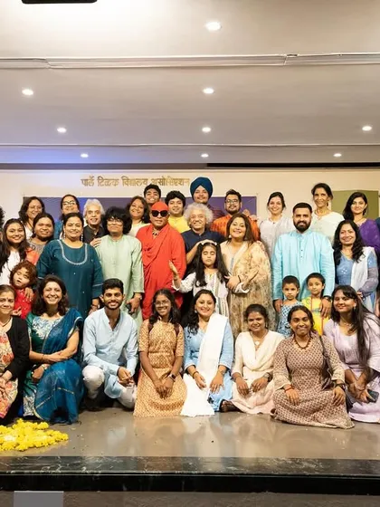 A group photograph with all the performers, guests, and students at the end of a successful Guruvandan. This picture captures the sense of community and shared joy that music brings.