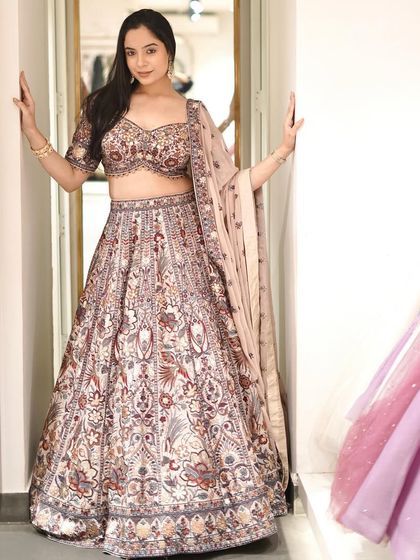 This heavily embellished lehenga is a masterpiece of craftsmanship, adorned with intricate details that tell a story of tradition.