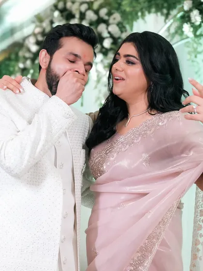 A candid moment of surprise and laughter between a couple at their engagement.