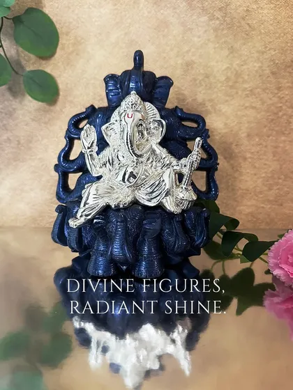 Divine figures, radiant shine. This silver-plated Ganesha sits upon a throne of elephants, a powerful symbol of wisdom and strength, designed to be a commanding presence in your home.