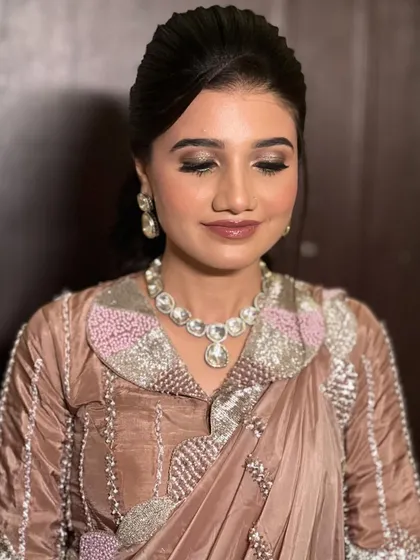 A sophisticated sangeet look with a unique collared blouse and a sleek ponytail.