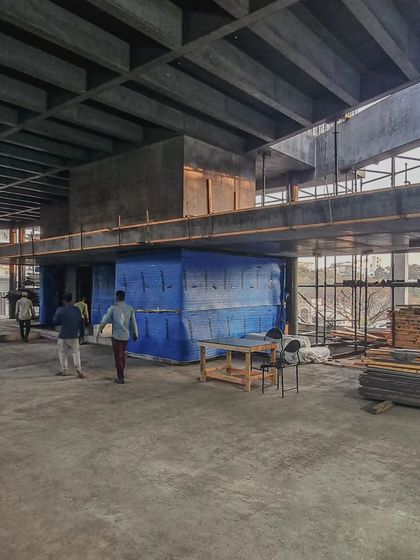 (Duplicate of 28) Workers walk through the double-height space of Office A, giving a sense of the scale of the project.