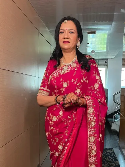 A graceful look for a family member. The client is wearing a beautiful pink saree, and her makeup is elegant and sophisticated.