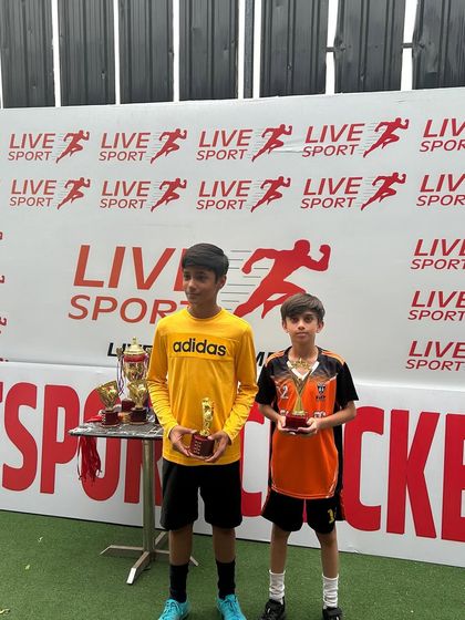 Two top performers from the U11 Junior Football League with their individual awards.