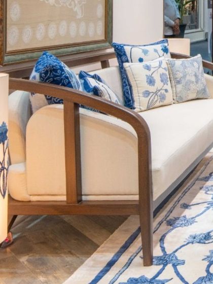 This custom-designed sofa features an unconventional, beautifully curved wooden frame. Paired with hand-spun khadi upholstery and indigo-hued cushions, it becomes a statement piece that balances artisanal craftsmanship with contemporary comfort.