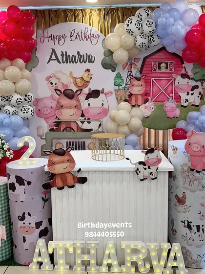 A charming farm animal theme for a second birthday party. This setup includes a barnyard backdrop, adorable animal cutouts, and custom marquee letters, creating a fun and friendly atmosphere for the little ones.