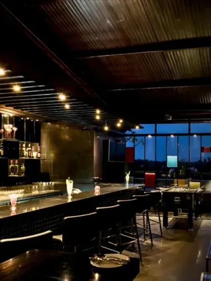 A meticulously designed bar lounge where luxury materials, atmospheric lighting, and spatial rhythm combine. We craft these commercial interiors to create an unforgettable evening experience defined by sophistication and comfort.