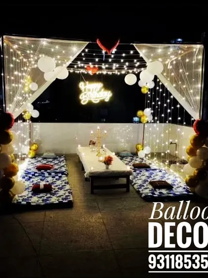 I can turn any terrace into a magical, starlit dining experience. This romantic birthday setup features a canopy draped with fairy lights, low seating with comfortable cushions, and elegant balloon decor for a private and unforgettable celebration.