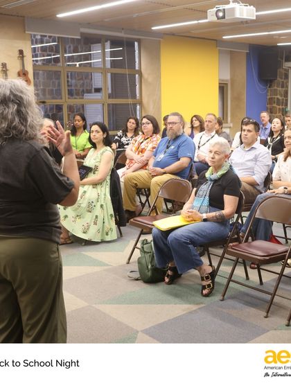 A teacher addresses parents at Middle School Back to School Night. These events are a cornerstone of our home-school partnership.